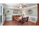Traditional dining room features wood floors, wainscoting, ceiling fan, and decorative accents at 1421 Eryn Cir, Suwanee, GA 30024