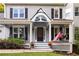 Inviting front porch with rocking chairs, an American flag, and decorative details at 1421 Eryn Cir, Suwanee, GA 30024