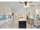 Updated kitchen featuring stainless steel appliances, white cabinets, and a center island with seating at 1421 Eryn Cir, Suwanee, GA 30024
