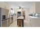 Modern kitchen with stainless steel appliances, white cabinets, and a center island at 1421 Eryn Cir, Suwanee, GA 30024