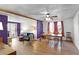 Open-concept living and dining area with hardwood floors, ceiling fan, and abundant natural light at 1421 Eryn Cir, Suwanee, GA 30024