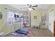 Bright home office with a stand up desk, large window and comfortable chair and colorful rug at 1421 Eryn Cir, Suwanee, GA 30024