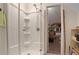 Modern shower with glass doors, multiple showerheads, and built-in shelving for toiletries and bath items at 1421 Eryn Cir, Suwanee, GA 30024