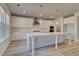 Bright and airy kitchen with a large island, white cabinets, stainless steel appliances, and luxury vinyl plank flooring at 108 Dalston Cv, Stockbridge, GA 30281