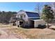 Exterior view of a barn with living space above and garage/storage below on this large property at 1370 A Cronic Town Rd, Auburn, GA 30011