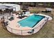 Sparkling in-ground pool with hot tub and chairs, all surrounded by a black fence at 1370 A Cronic Town Rd, Auburn, GA 30011