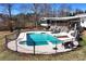 Aerial view of an in-ground pool with fencing, a hot tub, pool-side seating, and a large deck at 1370 A Cronic Town Rd, Auburn, GA 30011