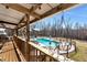 View of the backyard in-ground pool with an attached hot tub, poolside seating, and covered deck at 1370 A Cronic Town Rd, Auburn, GA 30011