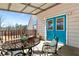 Relaxing porch area showcasing a wrought iron table and chair set, complete with bright blue doors at 1370 A Cronic Town Rd, Auburn, GA 30011