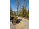 Professionally landscaped backyard features a stone path, mature trees, and lush greenery at 5650 Copper Creek Pass, Cumming, GA 30040