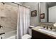 Well-lit bathroom with a shower-tub combo and marble-like tile at 5650 Copper Creek Pass, Cumming, GA 30040