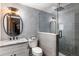 Modern bathroom with glass shower, gray herringbone tile, and updated fixtures at 5650 Copper Creek Pass, Cumming, GA 30040