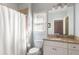 Well-lit bathroom with shower-tub combo, single granite vanity, and neutral color scheme at 5650 Copper Creek Pass, Cumming, GA 30040