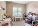 Bright, carpeted ' bedroom with a study area, play area, and window light at 5650 Copper Creek Pass, Cumming, GA 30040