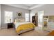 Bright bedroom with two windows, a queen bed, a bookcase, and a view into the bathroom at 5650 Copper Creek Pass, Cumming, GA 30040