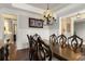 Sophisticated dining room with a large wooden table, wainscoting, and a view into the adjacent rooms through wide archways at 5650 Copper Creek Pass, Cumming, GA 30040