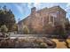 A backyard view of a large brick home with a covered deck at 5650 Copper Creek Pass, Cumming, GA 30040