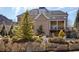 A backyard view of a brick home with a covered deck and manicured landscaping at 5650 Copper Creek Pass, Cumming, GA 30040