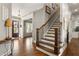 Inviting foyer with hardwood floors and a staircase with iron balusters at 5650 Copper Creek Pass, Cumming, GA 30040