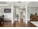 Elegant home foyer with hardwood floors, white columns, wainscoting, and a staircase leading to the upper level at 5650 Copper Creek Pass, Cumming, GA 30040