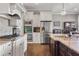 Well-equipped kitchen with stainless steel appliances, granite counters, and white cabinets at 5650 Copper Creek Pass, Cumming, GA 30040