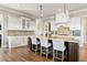 Spacious kitchen with a large center island, granite countertops, and custom white cabinets at 5650 Copper Creek Pass, Cumming, GA 30040