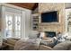 Comfortable living room with stone fireplace, built-in shelves, and natural light at 5650 Copper Creek Pass, Cumming, GA 30040