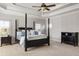 Well-lit main bedroom featuring a coffered ceiling, fan, and windows at 5650 Copper Creek Pass, Cumming, GA 30040