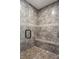 Tiled walk-in shower with a built-in bench seat at 5650 Copper Creek Pass, Cumming, GA 30040