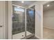 Modern tiled shower with glass doors and a window for natural light at 120 Dalston Cv, Stockbridge, GA 30281