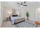 The bright main bedroom features a ceiling fan, a neutral palette, and contemporary furnishings at 1901 Lullwater Cir, Jonesboro, GA 30236