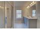 Bathroom featuring a glass enclosed shower, double sink vanity with gray cabinetry and granite counters at 208 Chiswick Loop, Stockbridge, GA 30281