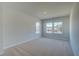 Bedroom with carpet flooring and multiple windows allowing for natural light at 208 Chiswick Loop, Stockbridge, GA 30281