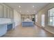 A spacious kitchen featuring gray cabinetry, a central island, and a stainless steel range hood at 208 Chiswick Loop, Stockbridge, GA 30281