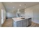 Kitchen island featuring sink and dishwasher with an open view of the living area at 208 Chiswick Loop, Stockbridge, GA 30281