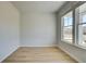 Versatile room with light wood floors, neutral paint, and large windows providing ample natural light at 208 Chiswick Loop, Stockbridge, GA 30281