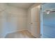 Walk-in closet with carpet, wire shelving, and white door at 208 Chiswick Loop, Stockbridge, GA 30281