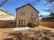 Exterior view of a backyard with patio and fence, set against the backdrop of a clear blue sky at 2470 Arnold Mill Rd, Lawrenceville, GA 30044