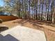 Backyard featuring a concrete patio next to a wooded area with tall trees at 2470 Arnold Mill Rd, Lawrenceville, GA 30044