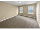 Bedroom with carpeted floors, two windows, and neutral décor at 2470 Arnold Mill Rd, Lawrenceville, GA 30044