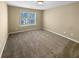 Bright bedroom featuring neutral walls, carpet, and a large window for ample natural light at 2470 Arnold Mill Rd, Lawrenceville, GA 30044