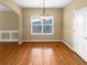 An inviting dining room offers gleaming wood floors and a modern chandelier illuminating the open space at 2470 Arnold Mill Rd, Lawrenceville, GA 30044