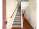 Welcoming entryway featuring carpeted stairs with wood banister and views into the living spaces at 2470 Arnold Mill Rd, Lawrenceville, GA 30044