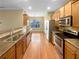 Modern kitchen with stainless steel appliances, wood cabinets, and hardwood floors at 2470 Arnold Mill Rd, Lawrenceville, GA 30044