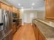 Well-lit kitchen with stainless steel appliances, wood cabinets, and long countertop at 2470 Arnold Mill Rd, Lawrenceville, GA 30044