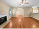 Open-concept living space with hardwood floors, fireplace, and view into dining area at 2470 Arnold Mill Rd, Lawrenceville, GA 30044