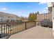 View of the back deck with a grill and overlooks the townhome community at 3908 Charleston Market St, Suwanee, GA 30024