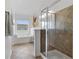 Bathroom featuring a glass-enclosed shower and soaking tub by a bright window at 3908 Charleston Market St, Suwanee, GA 30024