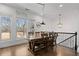 Elegant dining area with hardwood floors, windows with natural light, and modern chandelier at 3908 Charleston Market St, Suwanee, GA 30024