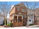 Stunning two-story brick home featuring a charming front porch with white pillars and a well-manicured lawn at 3908 Charleston Market St, Suwanee, GA 30024